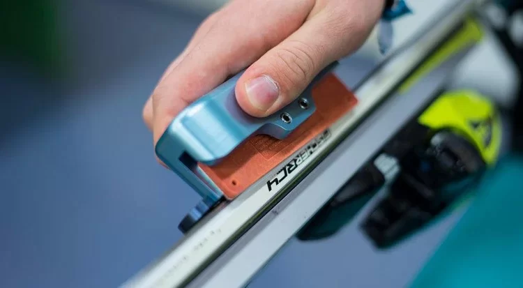 Affûtage des carres d'un ski de compétition dans un atelier